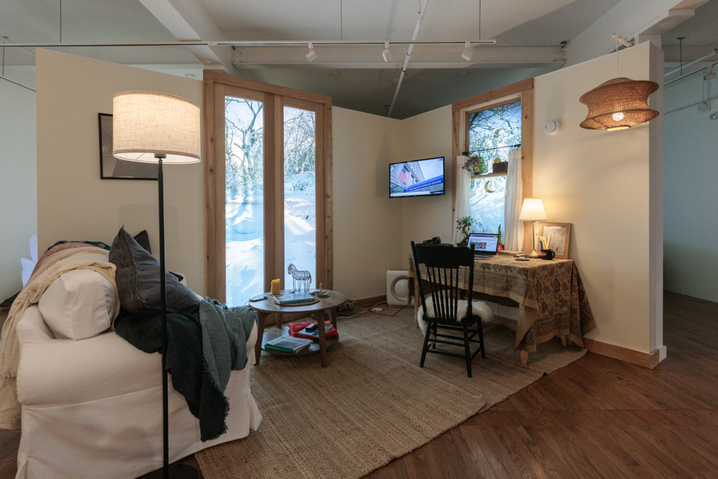 Room Three installation interior with seating and multiple TV screens