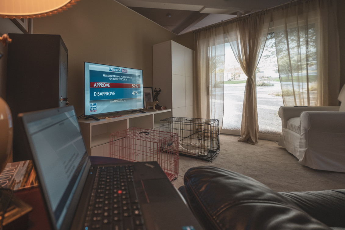 Room One installation interior with seating and multiple TV screens